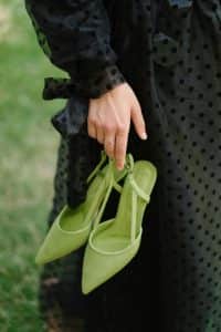 Find ways to enhance your wardrobe by speaking with Personal Image Consultant Beth Divine image shows pair of green shoes in hand