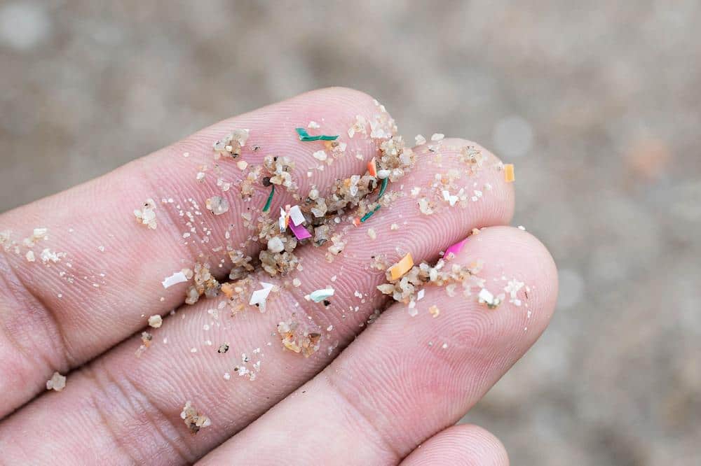 Personal Image Consultant Beth Divine encourages reducing microplastic pollution with clothing image shows fingers with microplastic materials