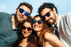 Indiana Personal Stylist Beth Divine advises wearing sunglasses that protect your eyes and fit your face shape image shows group of people wearing sunglasses