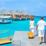 Learn some pointers for packing for a beach trip from Personal Image Consultant Beth Divine image shows couple arriving for a vacation