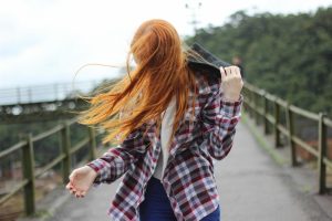 Beth Divine Style offers Indianapolis Color Analysis services image shows woman with red hair standing outside