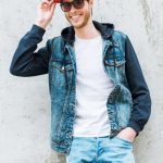 Denser materials like denim can add visual weight according to Men's Personal Stylist Beth Divine image shows man wearing denim jacket