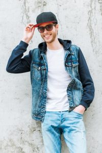 Denser materials like denim can add visual weight according to Men's Personal Stylist Beth Divine image shows man wearing denim jacket