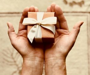 Indianapolis Men's Styling expert Beth Divine recommends buying quality for the men in your life image shows wrapped box in hands