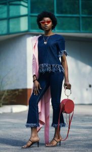 Indianapolis Personal Stylist Beth Divine says purses will show up in larger sizes in Spring 2026 image shows woman holding purse