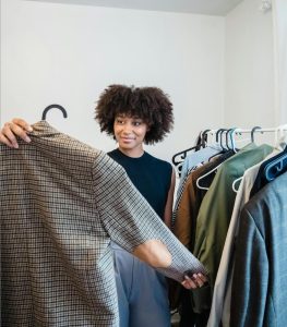 Reduce decision fatigue with help from Indianapolis Wardrobe Stylist Beth Divine image shows woman reviewing collection of clothes