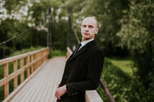 Work with Carmel Personal Stylist Beth Divine to determine the best suit option for you image shows man wearing suit on bridge