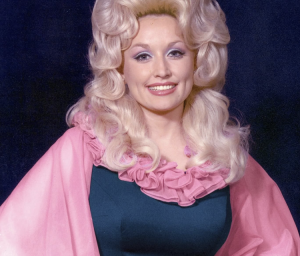 Dolly Parton wearing pink and blue outfit