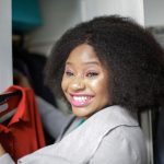 Make purchases you end up wearing with help from Carmel Wardrobe Stylist Beth Divine image shows smiling woman holding red shirt on hanger